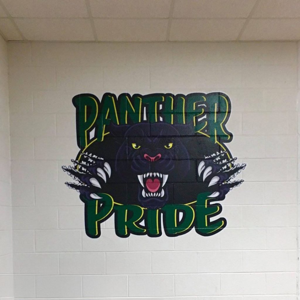 Large Panther Pride wall mural installed in a school hallway, adding color and school spirit to an otherwise plain corridor.