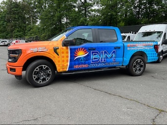 Pickup truck vehicle wrap created by a local print shop to match BIM’s existing fleet branding.