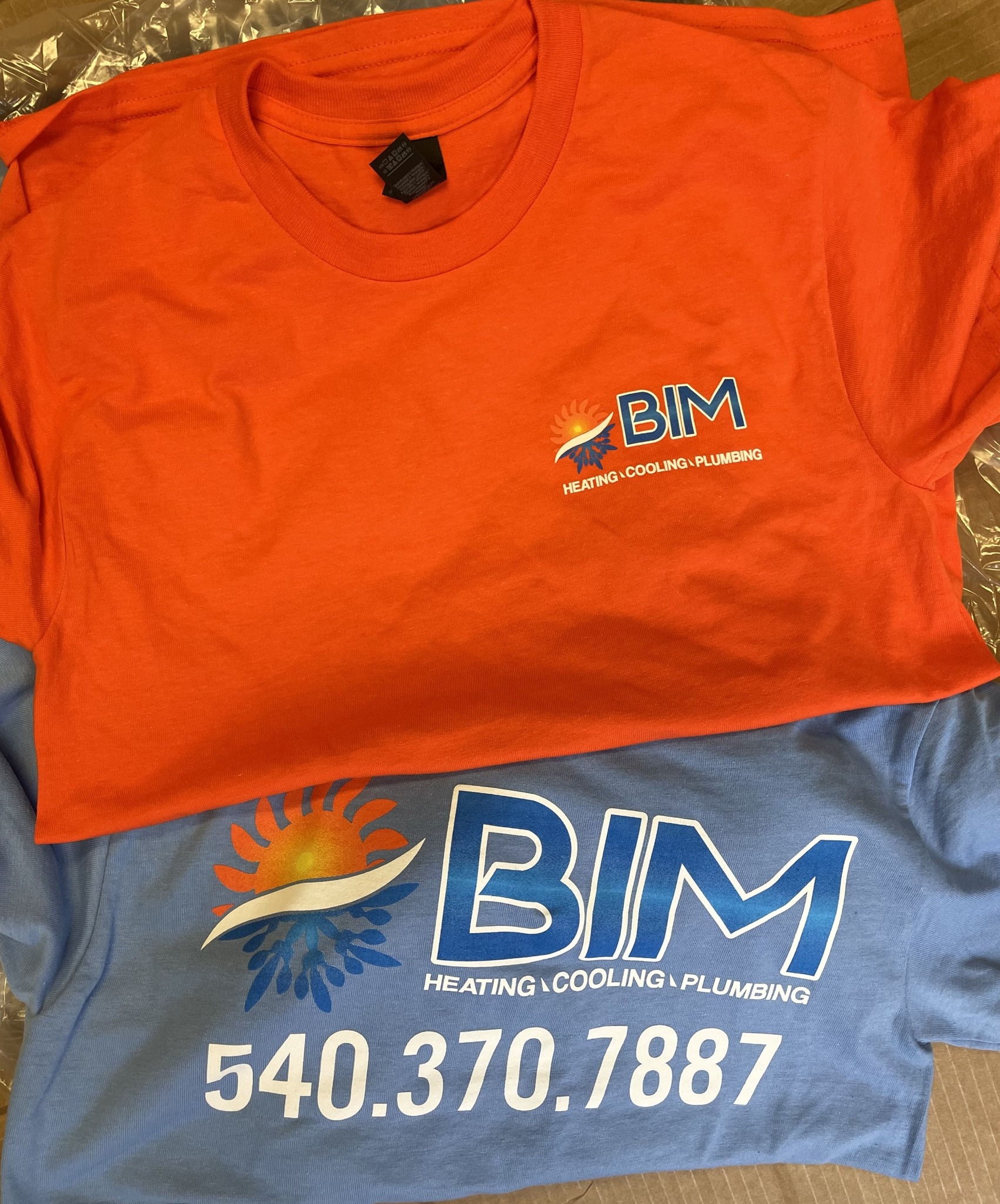 Custom branded shirts printed by a local print shop for BIM’s heating, cooling, and plumbing team.