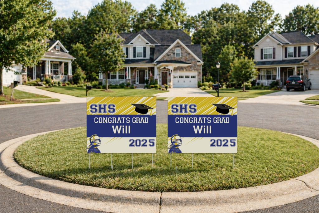 Custom graduation yard signs for Will displayed at the center of a neighborhood cul-de-sac with school colors, graduation cap graphic, and class year